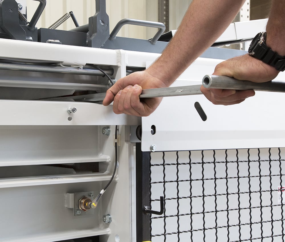 Manual bale strapping with continuous polyester tape